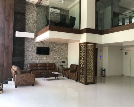 alt-text Hotel lobby with a sofa set | Kyriad Hotels, Solapur