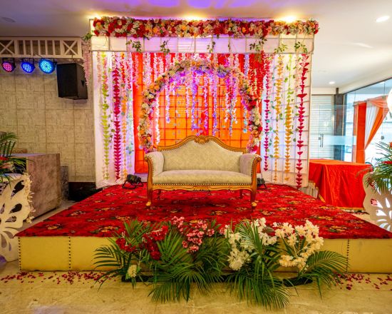 alt-text A front view of a stage decorated with flowers | Sun Park Hotel & Banquet, Chandigarh - Zirakpur