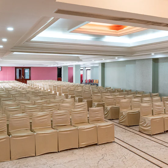 Side view of Banquet Hall with multiple chairs and modern interior - Hotel Ram International, Pondicherry