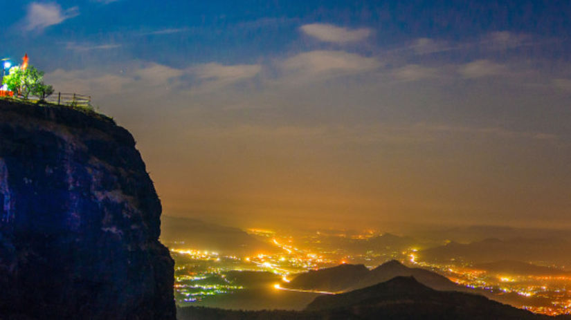 a panoramic view of a hill during night time