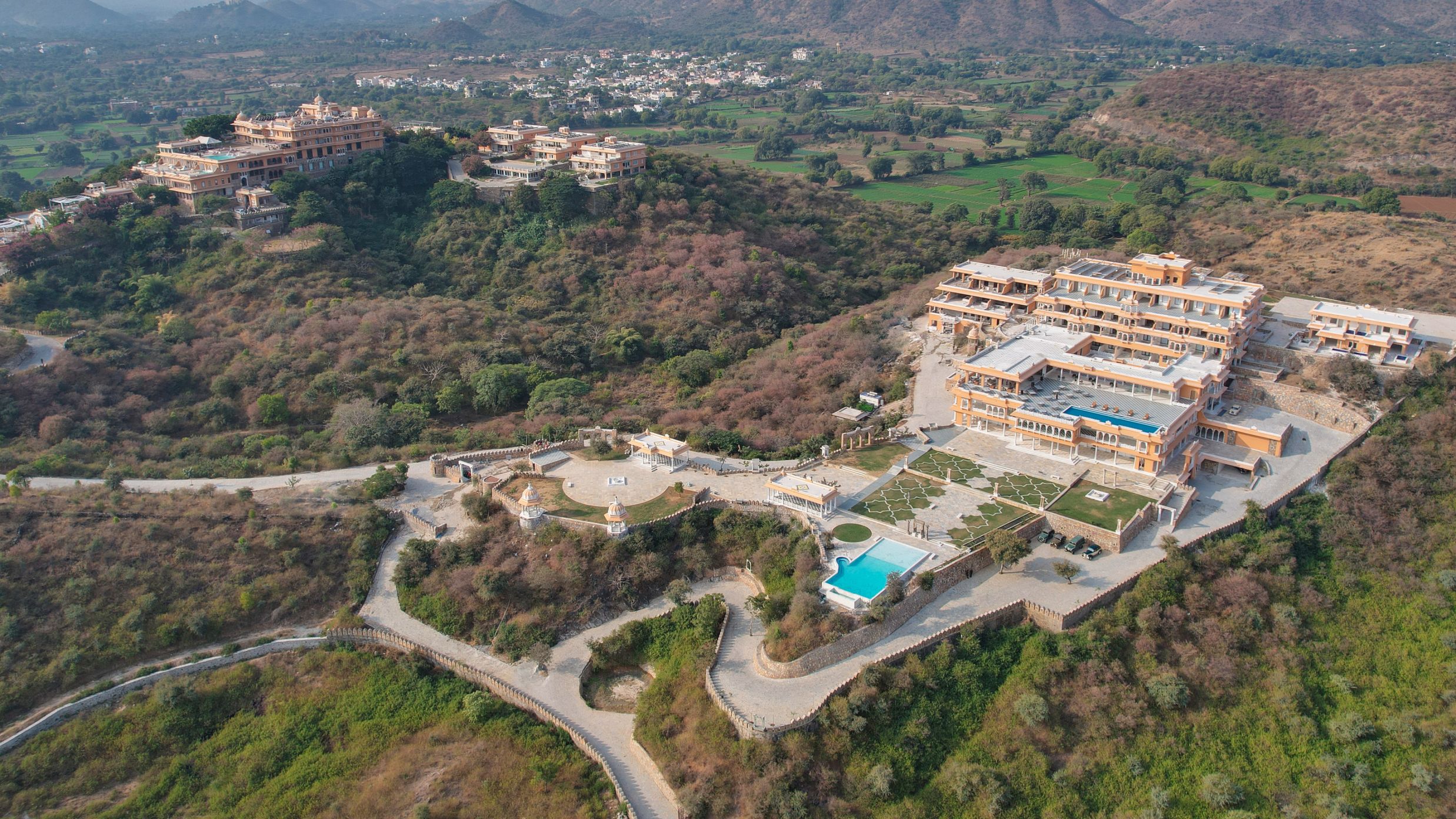 birdeye view of Fateh Vilas surrounded by green mountains