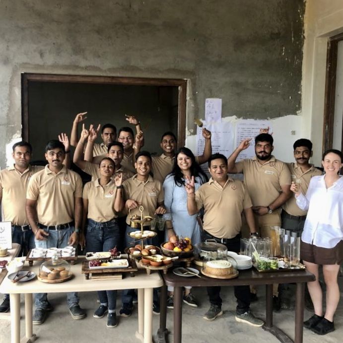 Hotel Staff posing for the camera behind the breakfast table