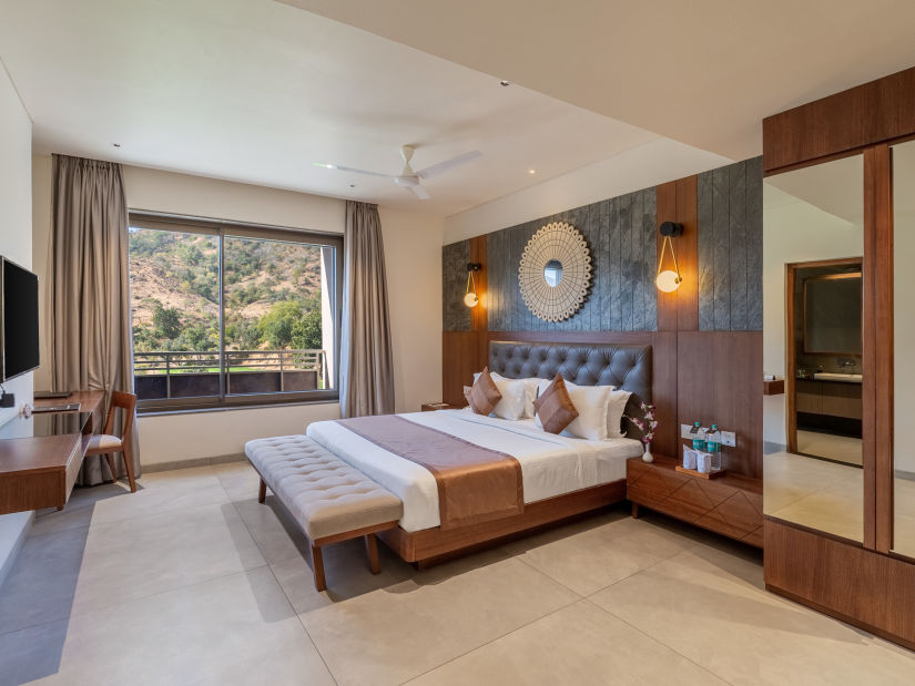 view of a king size bed and TV of Suite at Stone Wood Hotel, Kumbhalgarh