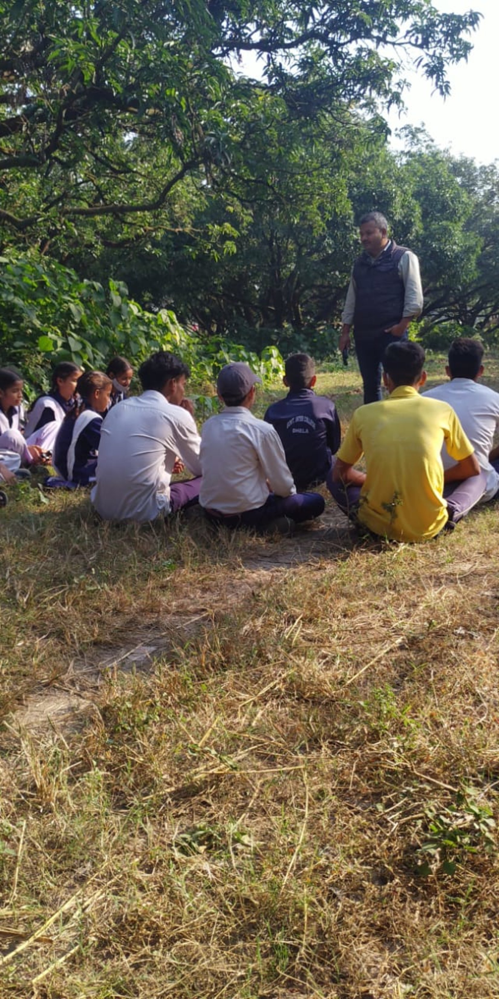 A person teaching the importance of recycling to a group of students at Golden Tusk