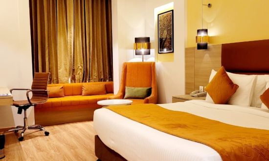 alt-text room with a king size bed and wooden flooring at best western vrindavan