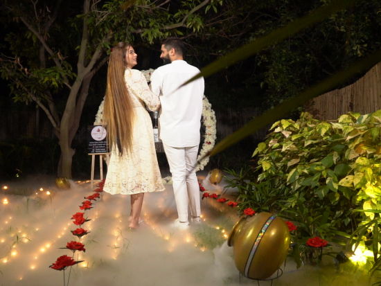 a couple walking on a road decorated with flowers at Themis Mudhouse - A Nature's Retreat Resort & Wellness