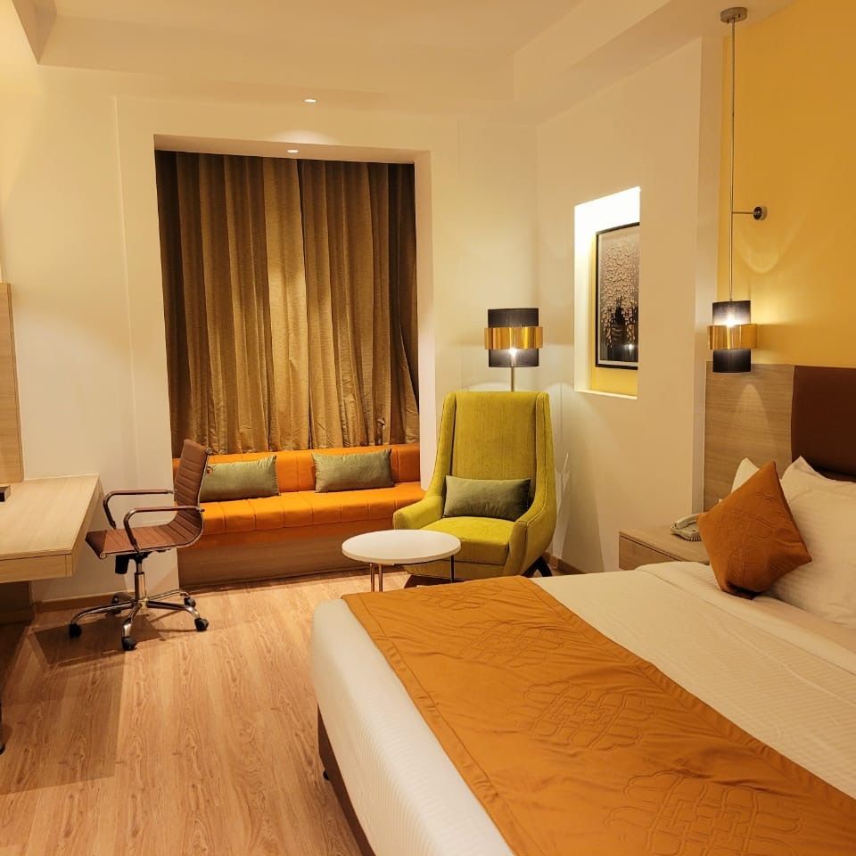 room with a king size bed and wooden flooring at best western vrindavan