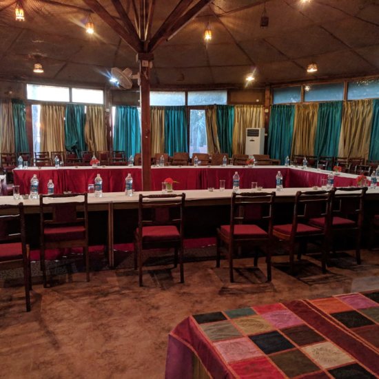 alt-text Tables and chairs aligned in a conference room