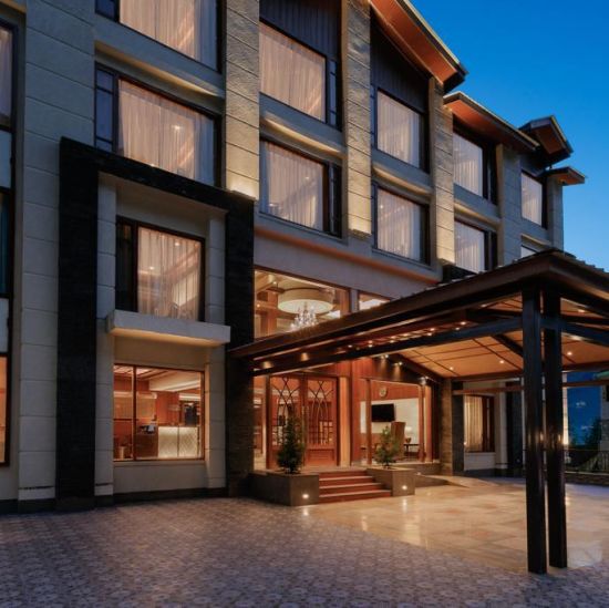 alt-text Entrance of The Orchid Hotel Manali with large windows