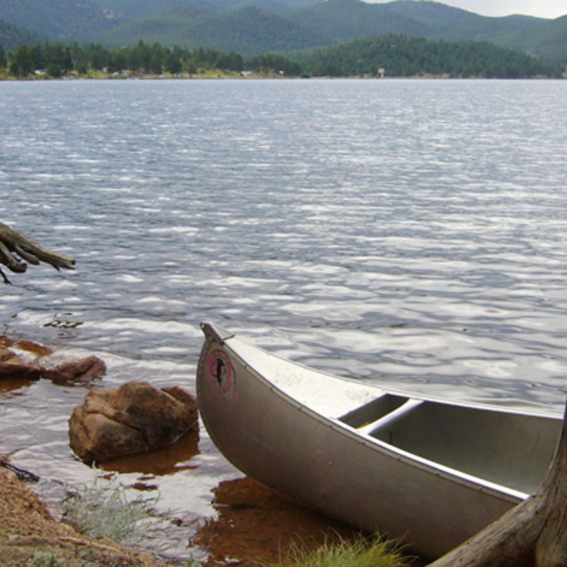 a solitary boat in wellington lake with land on the other side