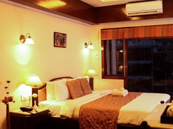 a distant picture of a bed in a room - Hotel Polo Towers, Shillong