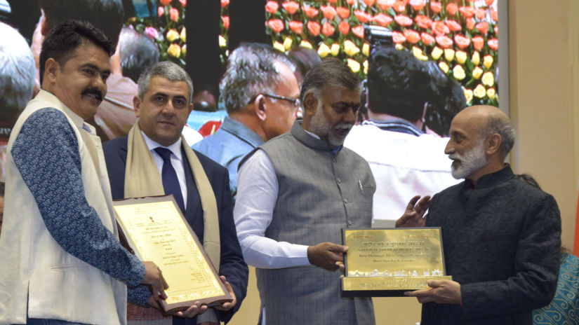 four men posing with awards 