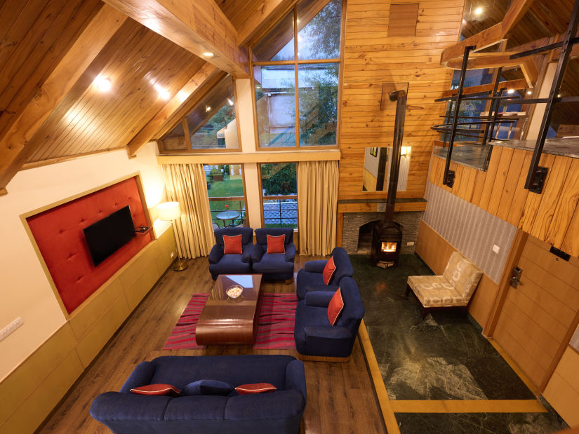 Renest Hotel Manali - INterior view of the living room from an elevated area 