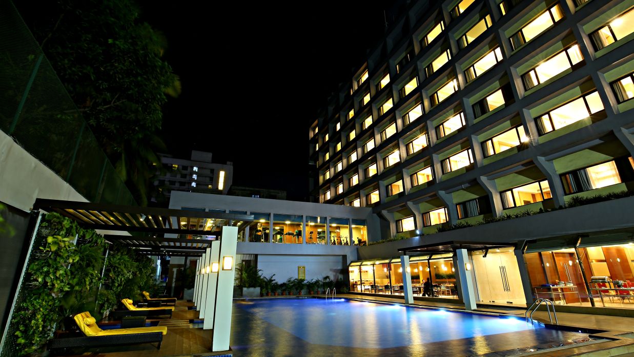 view of the pool and the hotel during night time