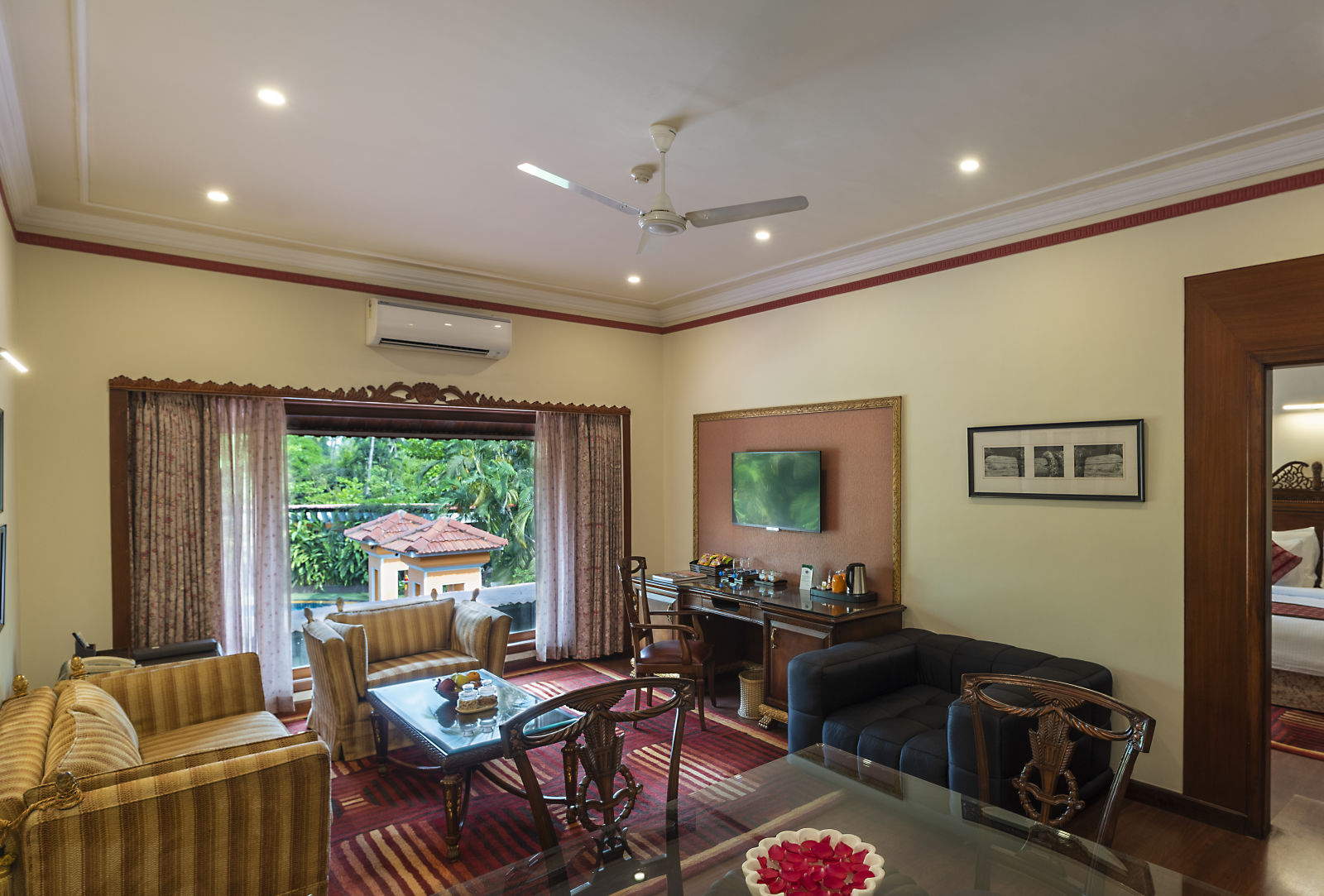 the living room decked with a sofa set and a TV - Mayfair Lagoon, Bhubaneswar