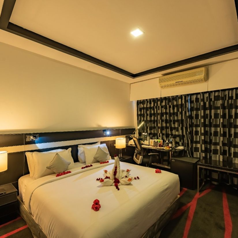 Premier AC room at the Pearl Hotel with a double bed and side stands - 2