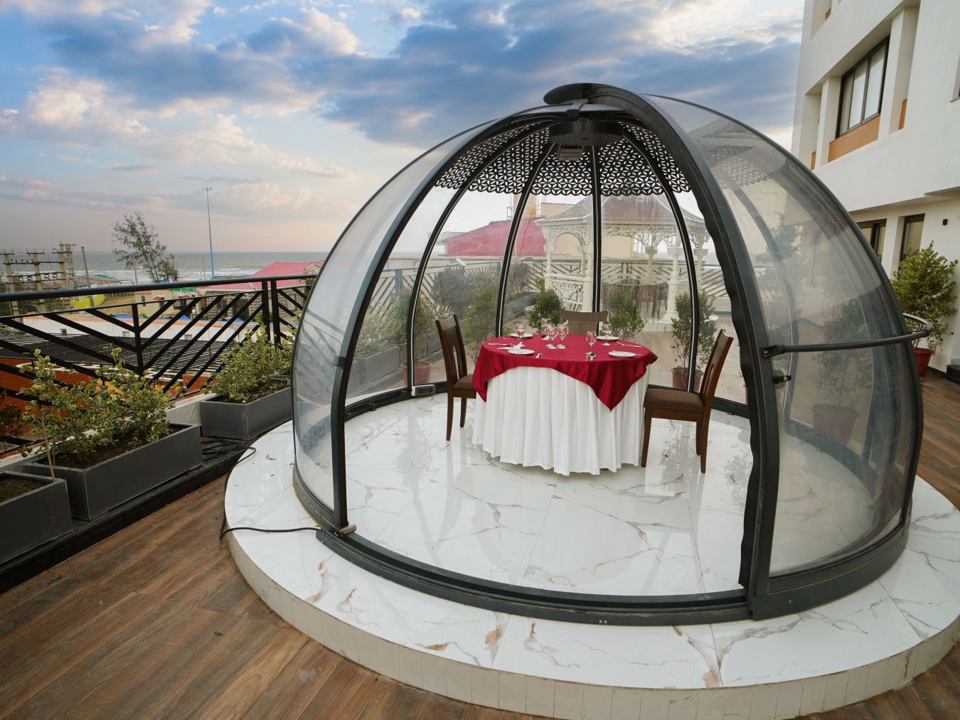 a half bubble kind of architecture with a table for two set inside it on the terrace - Shanti Seaview Resort & Spa - Hotels in Mandarmani Sea Facing