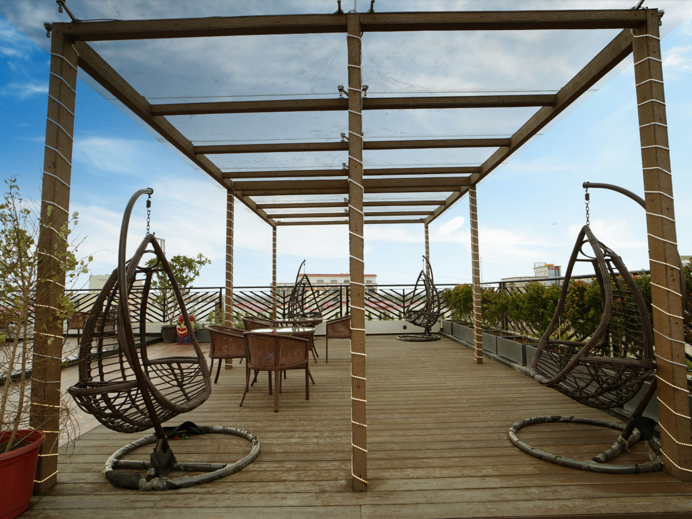 Two single seater hanging seats on the terrace with a see through roof - Shanti Seaview Resort & Spa