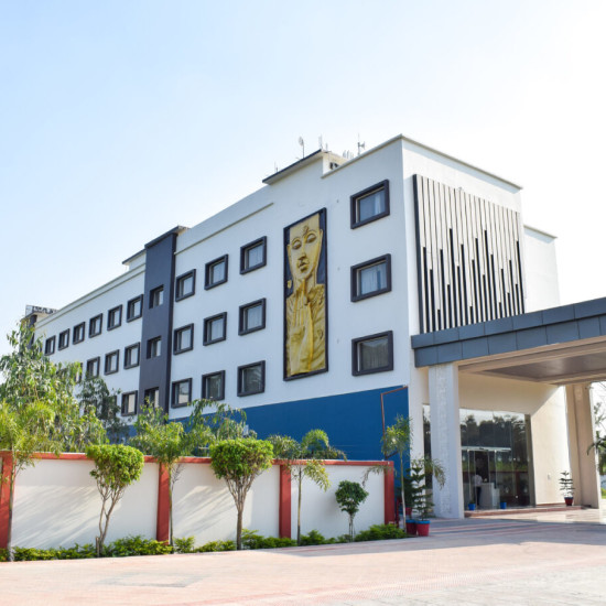 Facade image with the entrance and a painting on the building at Tulip Inn, Shravasti