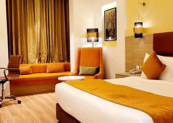 alt-text room with a king size bed and wooden flooring at best western vrindavan