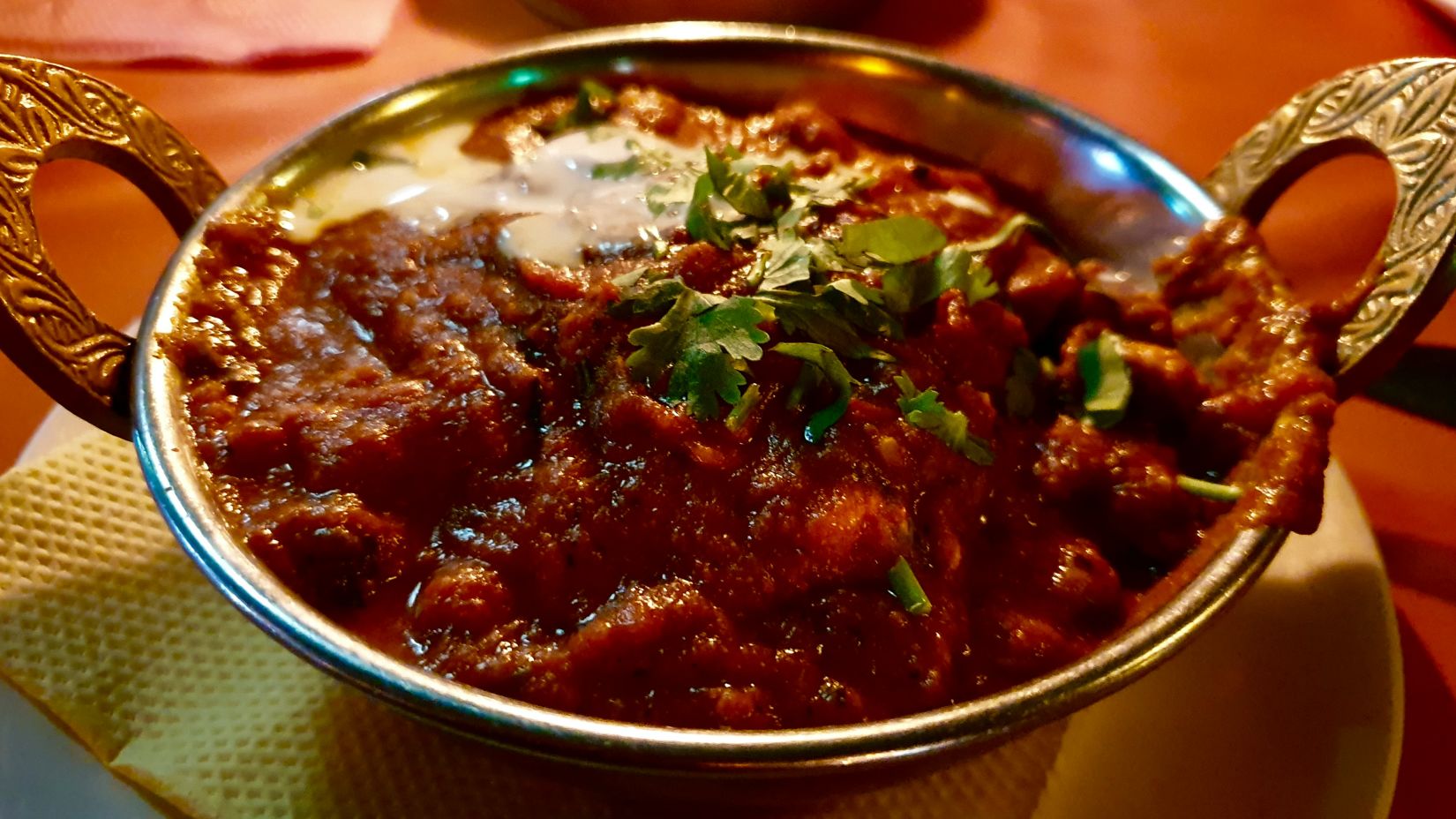 a close up shot of a dish called laal maas in a bowl 