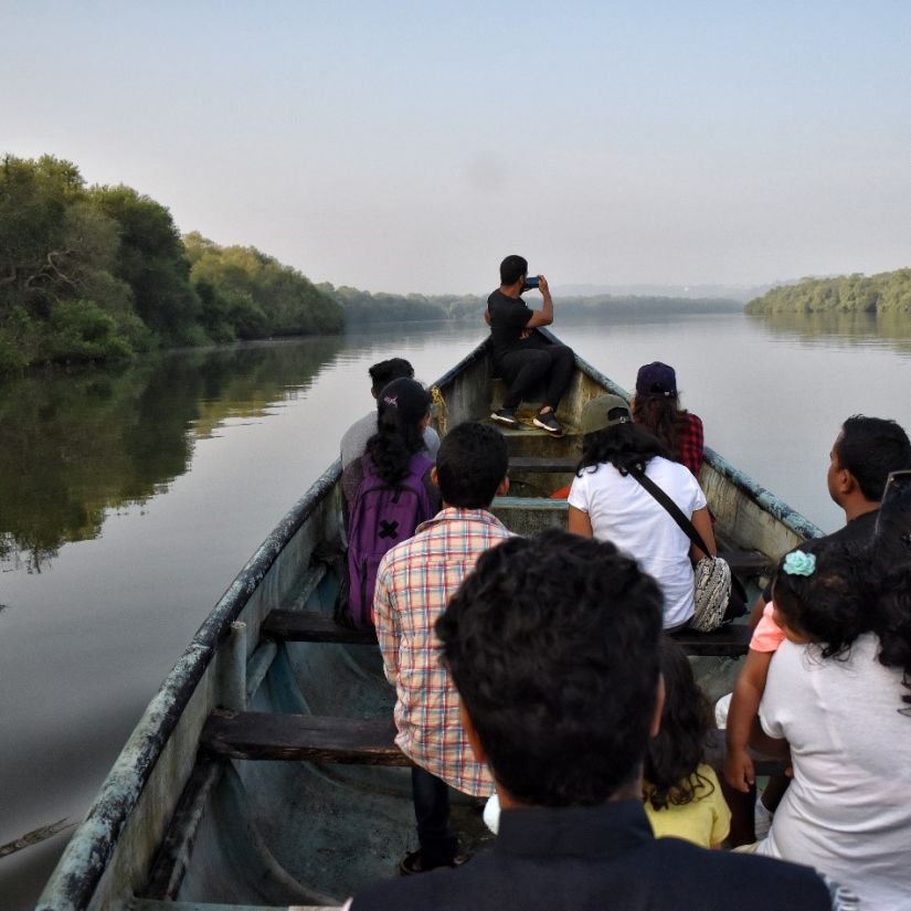 people on a boat at chorao