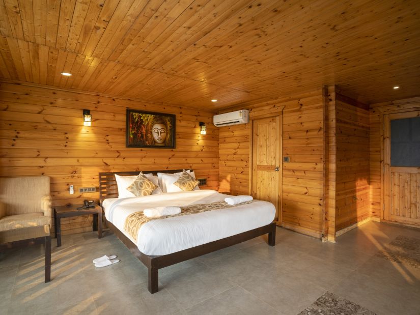 The wooden interiors of the Family Cottage Bedroom - Stone Wood Riverfront Resort, Siolim