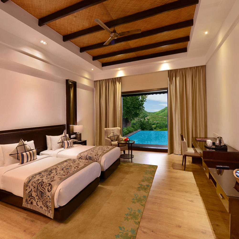 A king size bed with floor to ceiling window at the Presidential suite - The Ananta Udaipur 