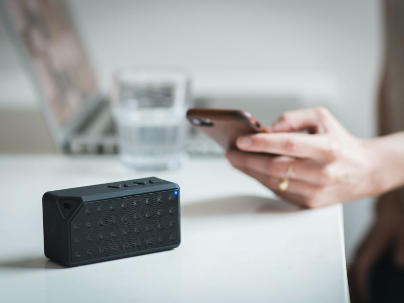 Image of a hand holding a phone and it seems like it is scanning a box