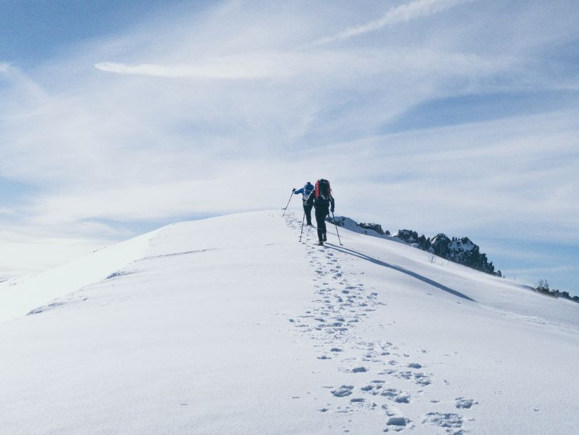 People hiking on the snow-capped mountains