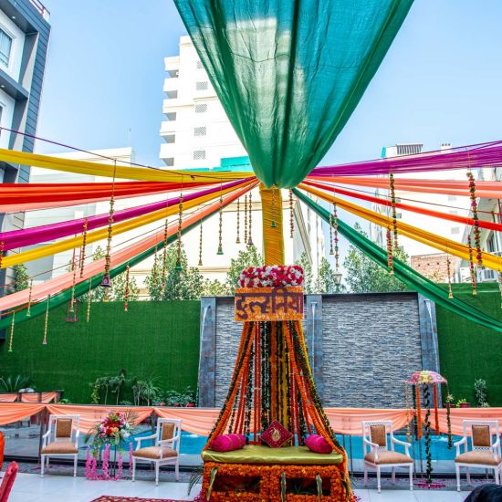 A low angle shot of a decorated event space beside the pool | Sun Park Hotel & Banquet, Chandigarh - Zirakpur