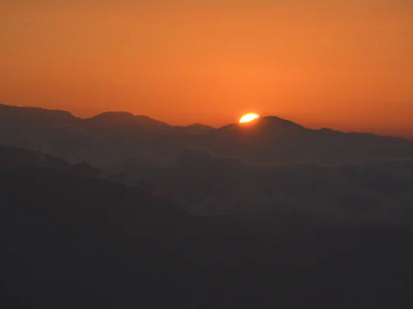 sun setting in the mountains