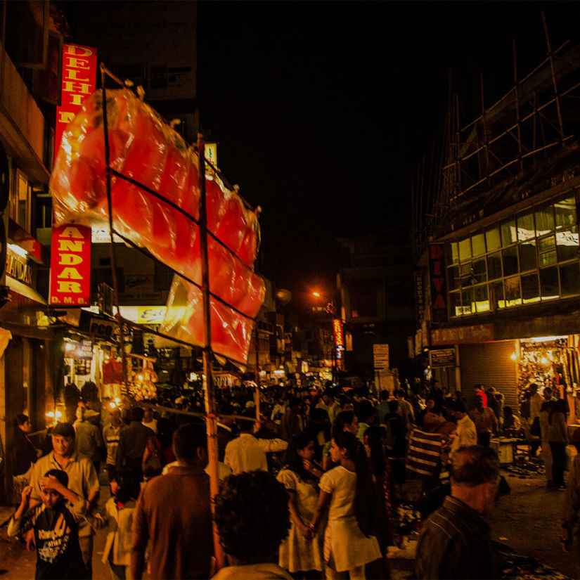 a crowd of people walking in a bazaar