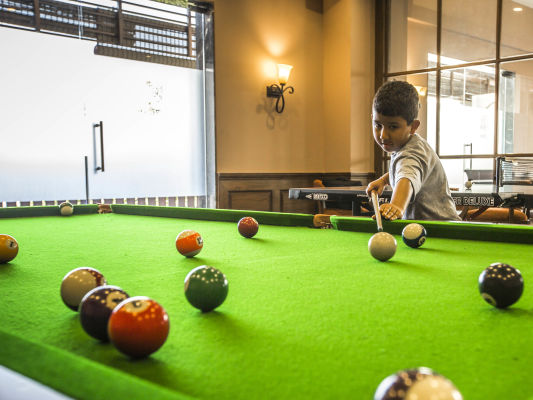 Kid playing pool ball