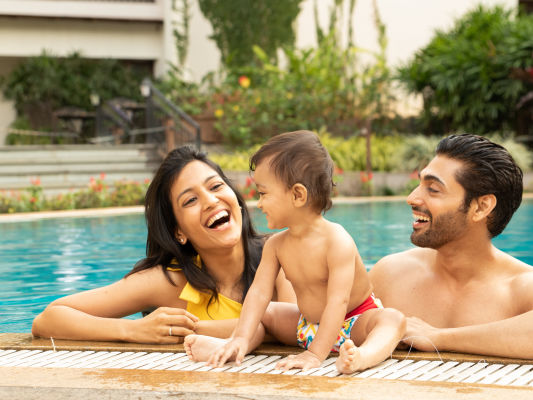 Parent and kid enjoying the swimming pool