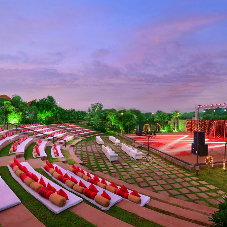 An overview of rangbhoomi amphitheatre with seating arrangements, lighting and speakers - The Ananta Udaipur