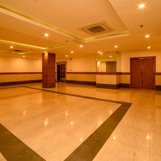 Another angle of a banquet hall with a marble floor, showcasing the expanse of the room and its warm lighting.