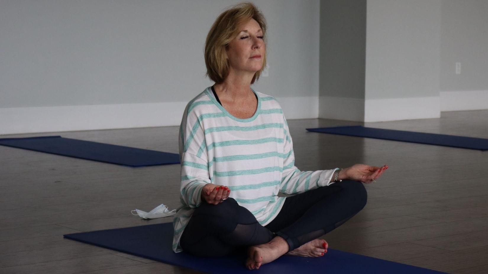 An elderly woman meditating.