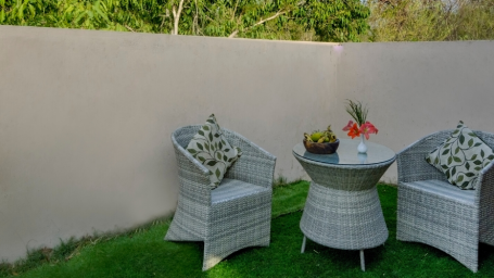 Two chairs and a coffee table in the sitting area | The Riverwood Forest Retreat, Pench