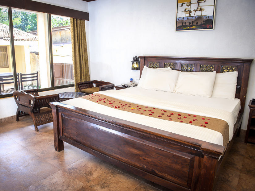 Adamo The Village - the balcony beside the king size bed offered at the Super Deluxe rooms in Matheran