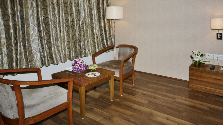 Wooden chairs and table arranged in a hotel room