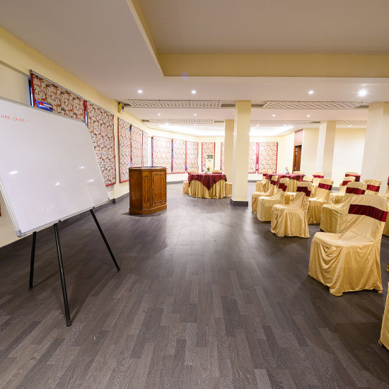 alt-text Conference room with round table seating arrangement and a whiteboard at Silver Sand Sentinel, Port Blair