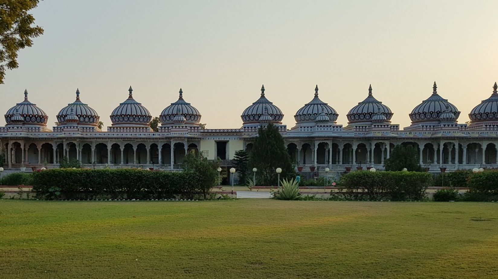 a temple in Bhilwara featuring a lawn during dayitime