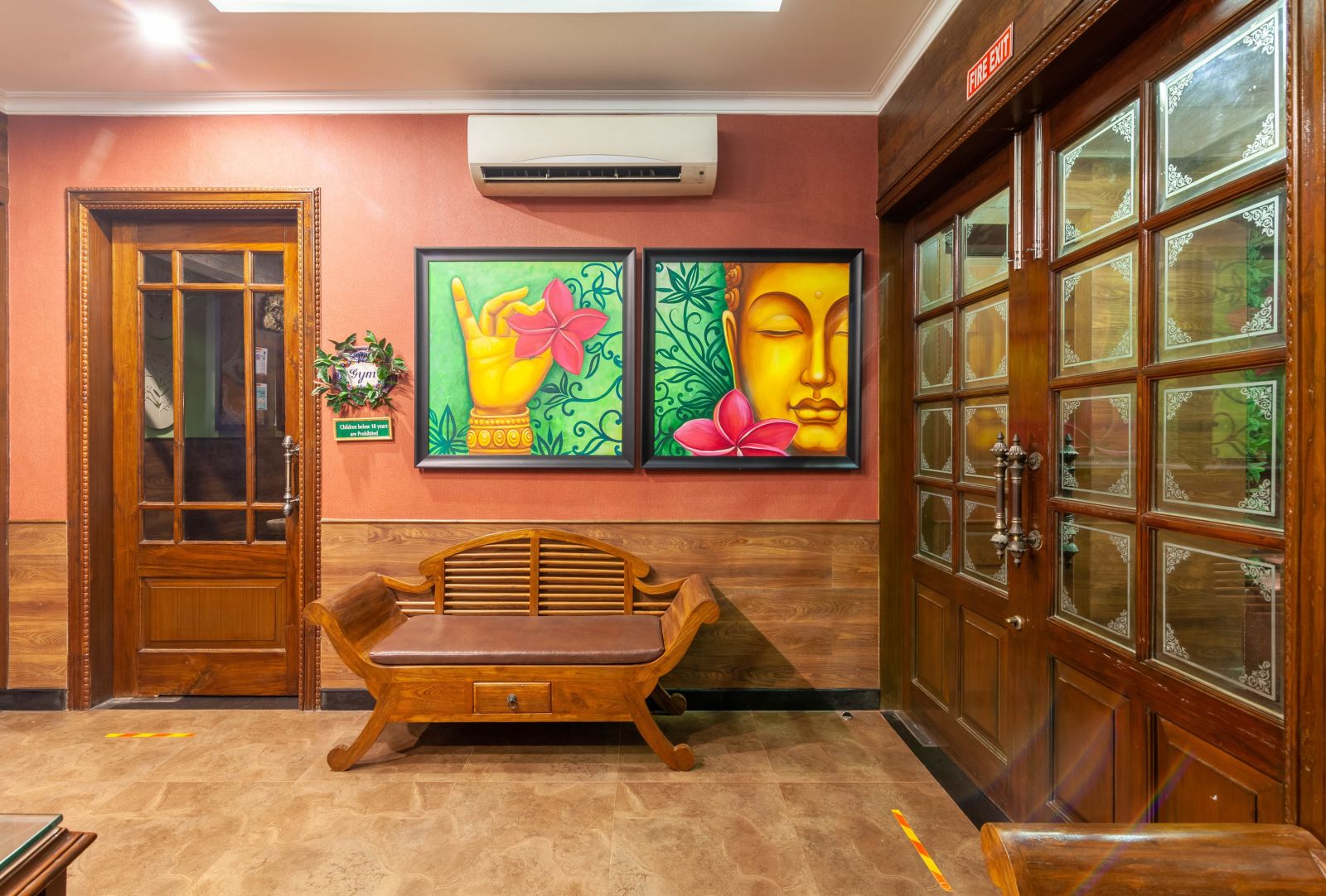 a wall filled with two paintings and a sofa in front of the wall - luxury hotels in gopalpur- Mayfair Palm Beach Resort, Gopalpur-on-Sea