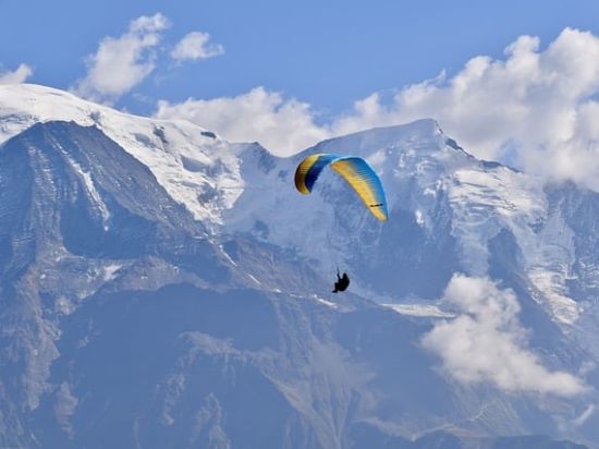 a person paragliding at a hill station