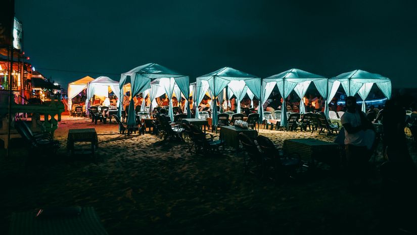 An outdoor area with seats under canopies at Calangute Beach