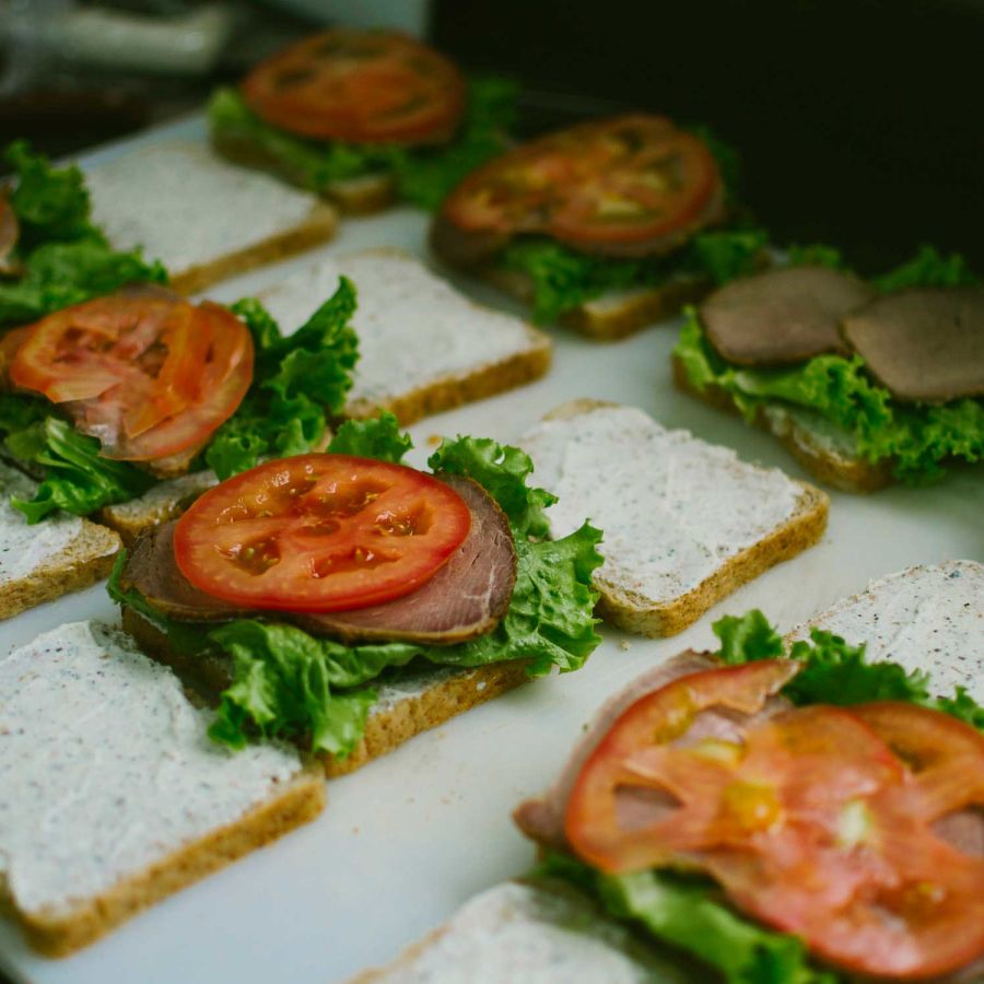 alt-text sandwiches kept open with a slice of tomato in the middle