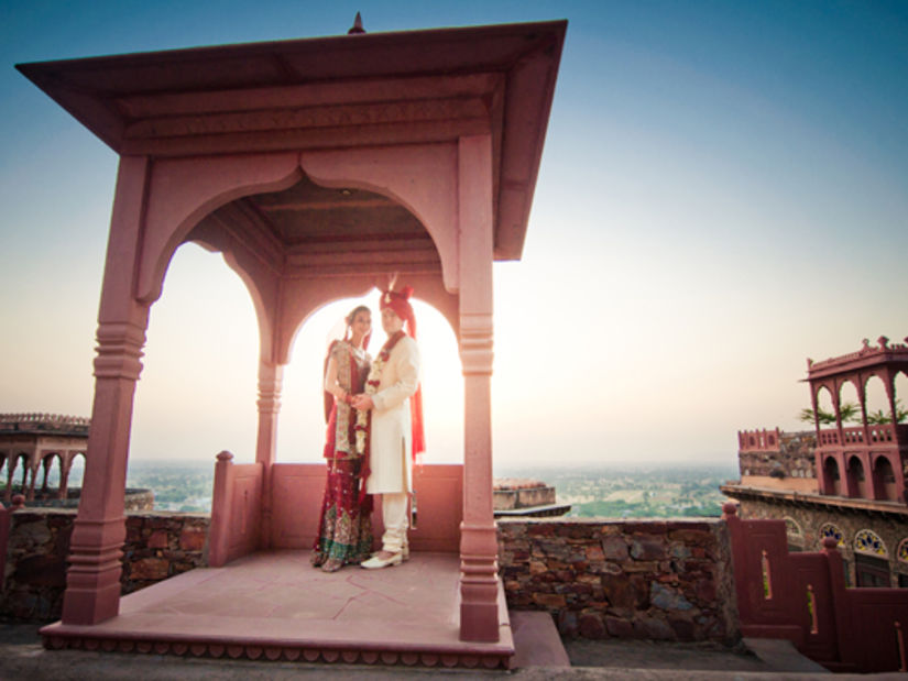 A bride and a bridegroom posing for a picture