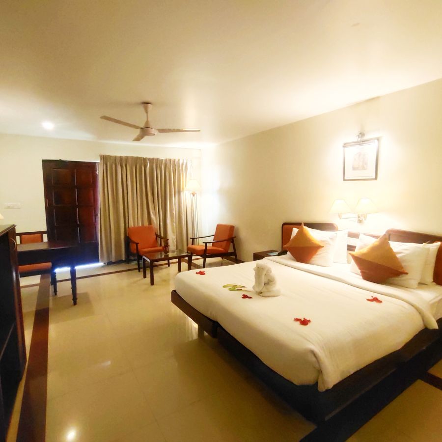 Beach Grove room with a double bed, wardrobe and seating arrangement