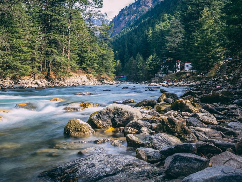 Glistening river flowing through the beautiful valley of Kasol - The Orchid Manali